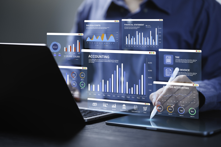A user analyzes digital dashboards showing financial data, highlighting the role of data augmentation in text data, image data, and audio data.