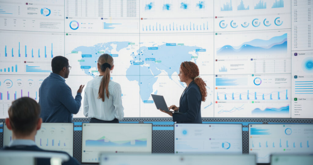Team analyzing global data dashboards after successful data migration, enabling real-time insights and improved decision-making.